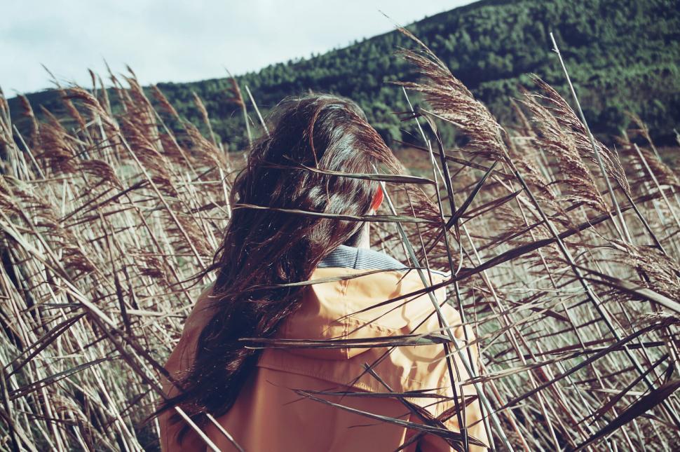 Free Image of Woman Standing in Field of Tall Grass 