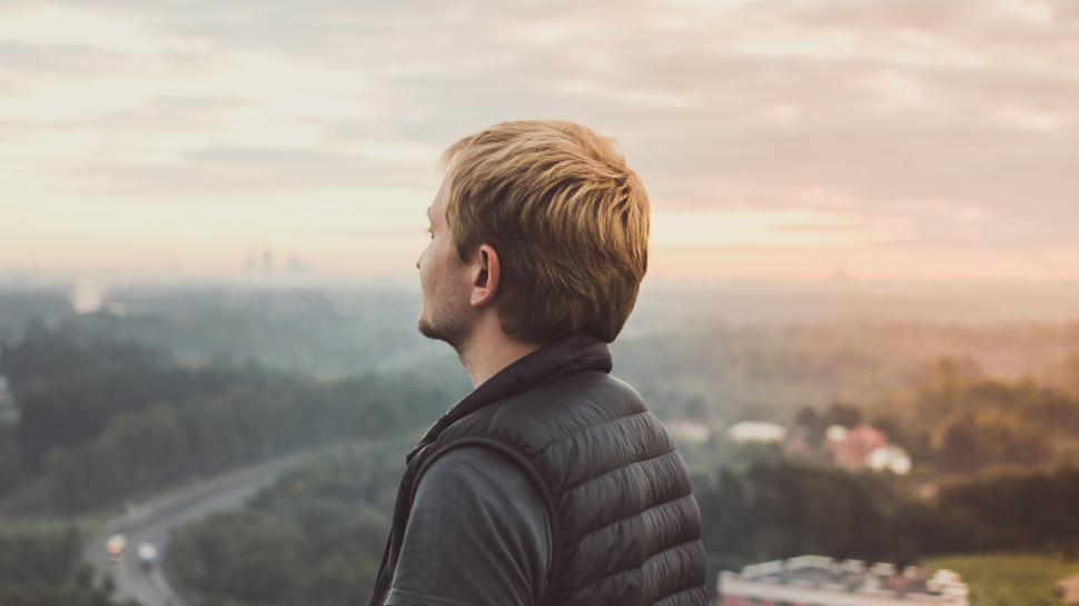 Free Image of Man Standing on Hill Overlooking City 