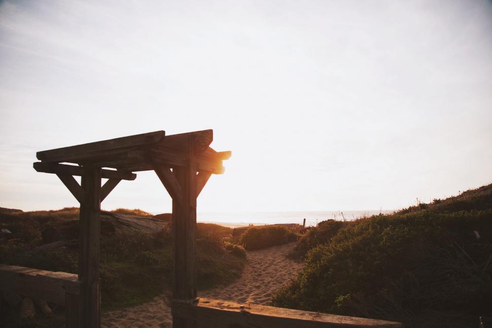 Free Image of Wooden Bench on Sandy Beach 