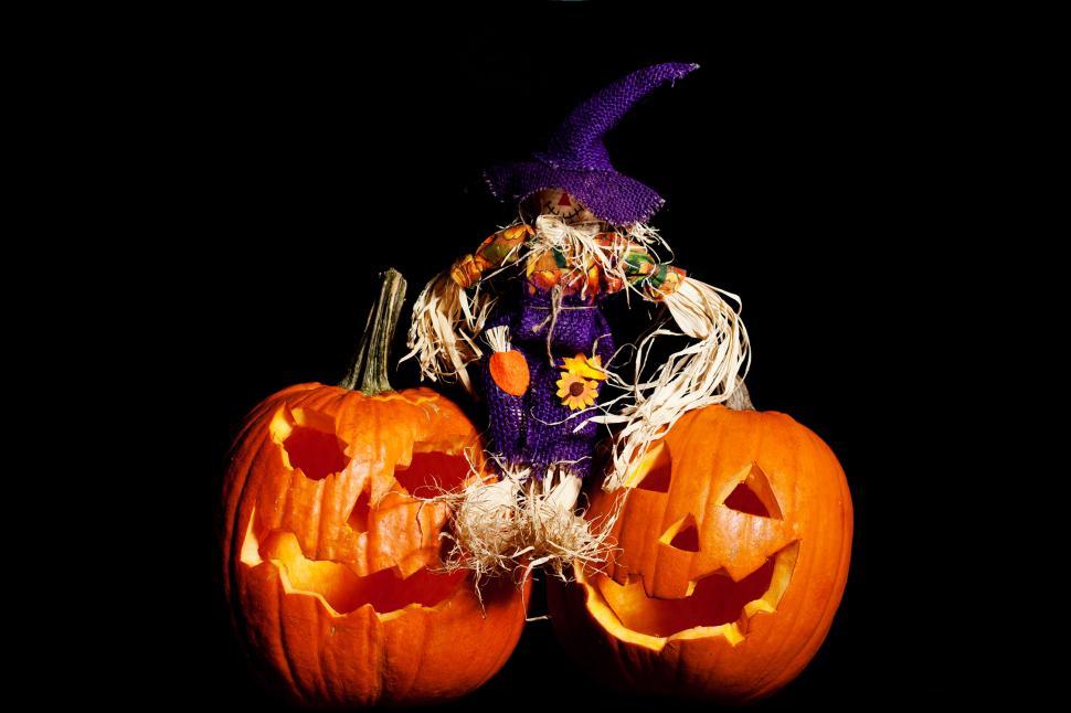 Free Image of Scarecrow sitting on  Pumpkins 