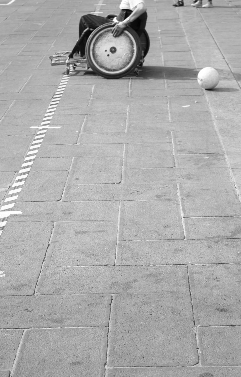 Free Image of Man in Wheelchair Sitting on Ground 
