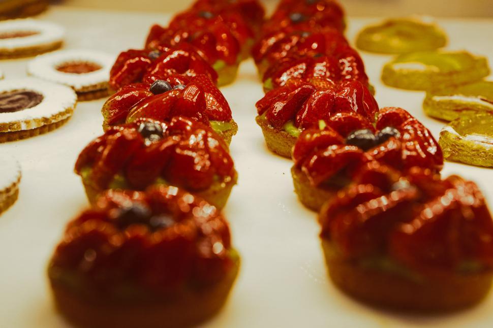 Free Image of Table Covered With Red Iced Donuts 