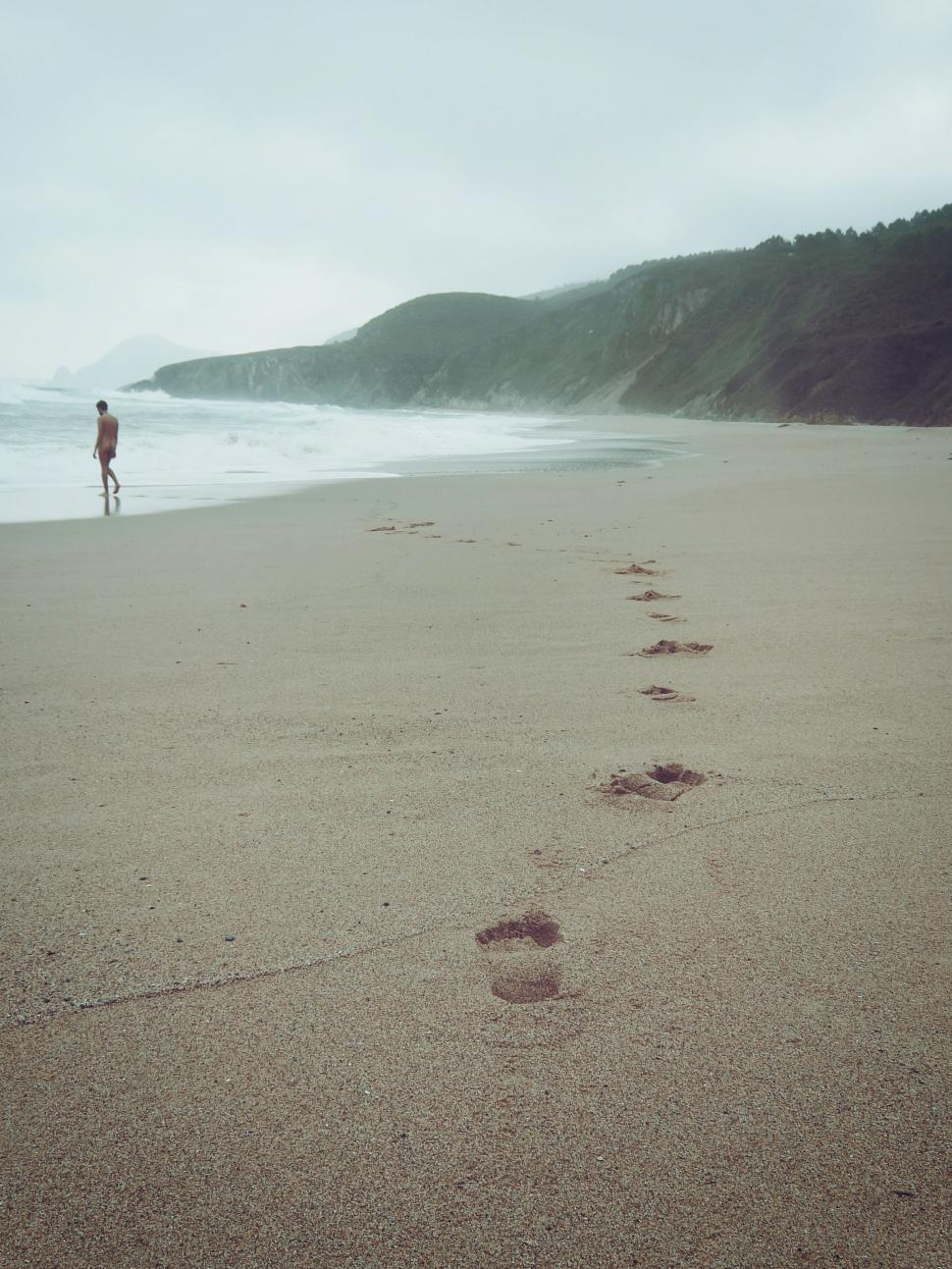 Free Image of Man on Sandy Beach Near Ocean 