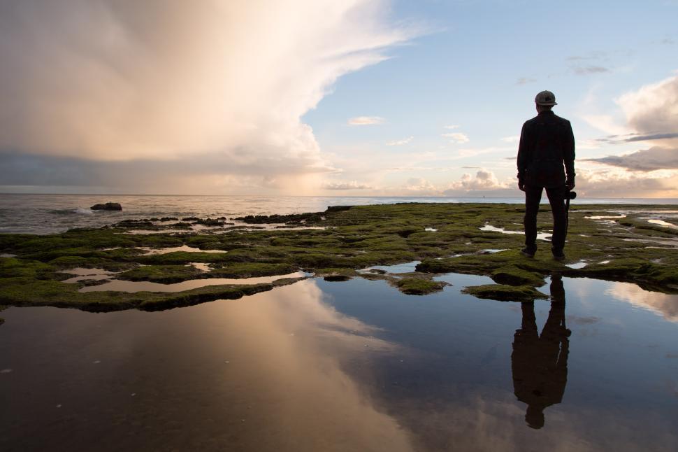 Free Image of Man Standing on Top of a Lush Green Field 
