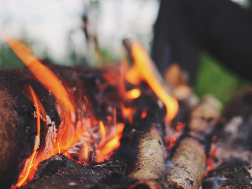 Free Image of Person Standing Near Roaring Fire 