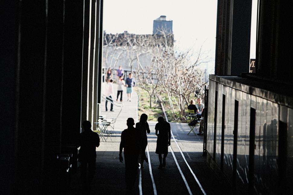 Free Image of Group of People Walking Down a Hallway 