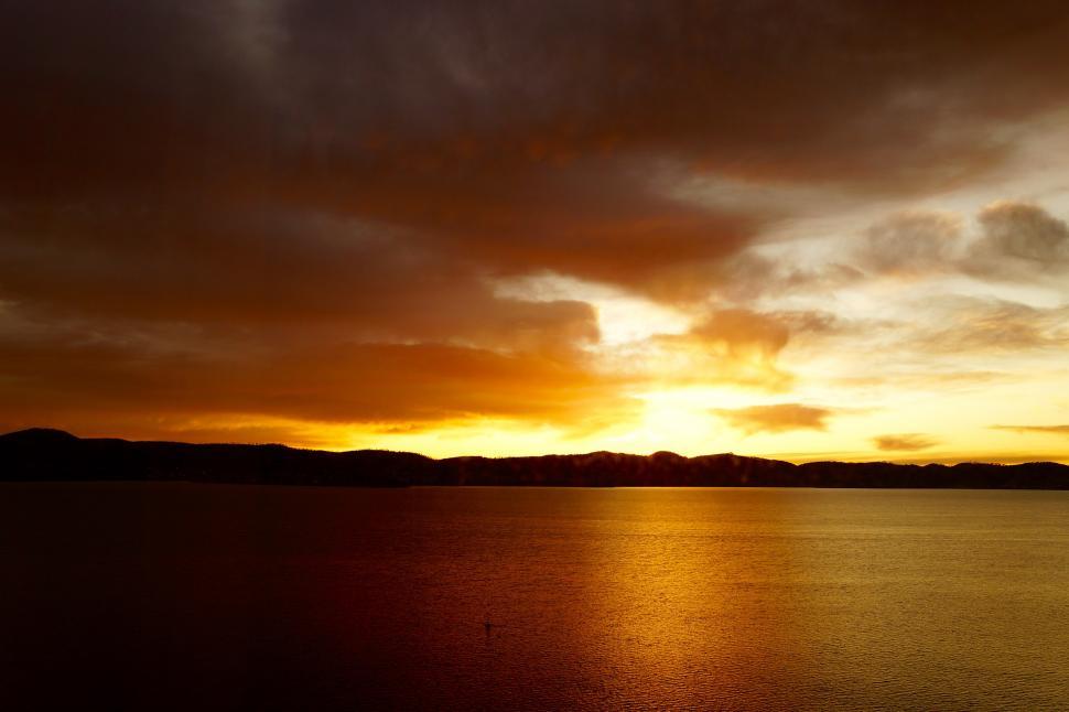 Free Image of Cloudy Sky Over Large Body of Water 