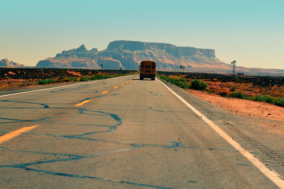 Free Image of Bus Driving Down Desert Road 