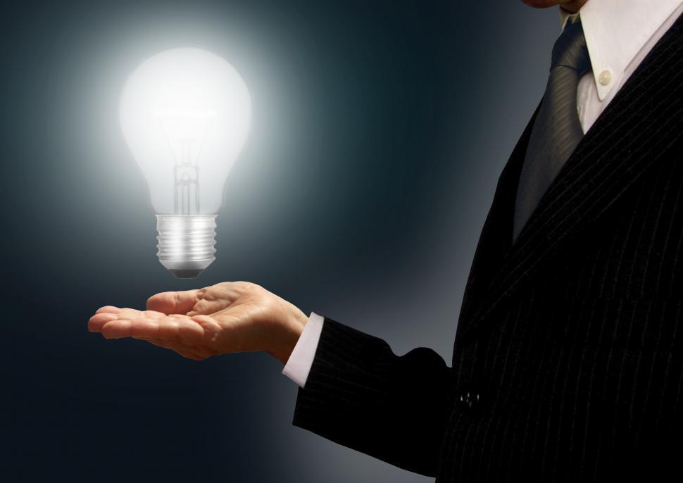Free Image of Businessman holding a lightbulb - Ideas and creativity concept 