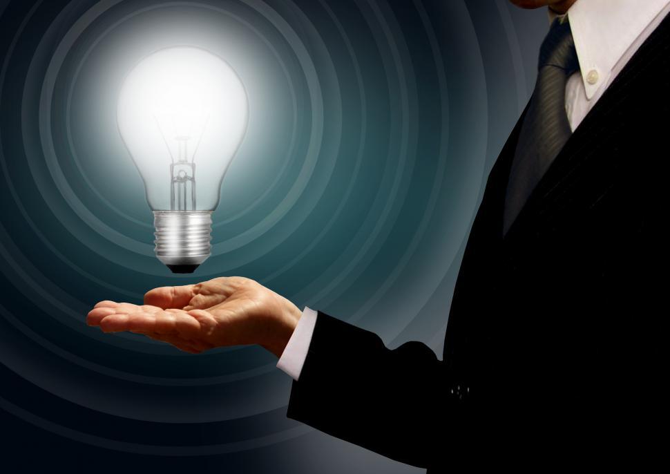 Free Image of Businessman holding a lightbulb - Ideas and creativity concept w 