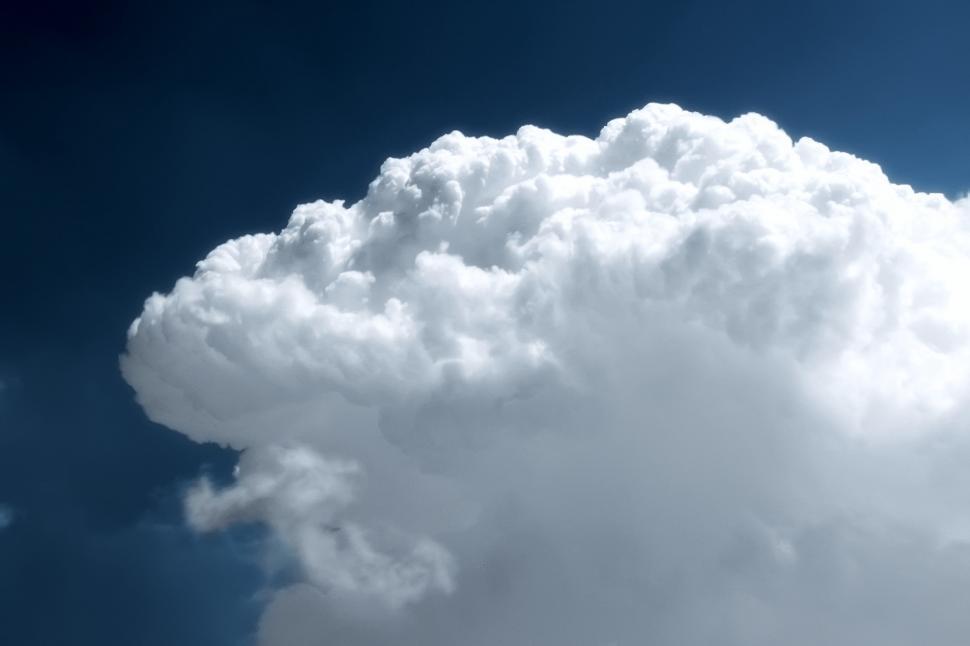 Free Image of Giant Cloud in Sky With Plane Flying By 
