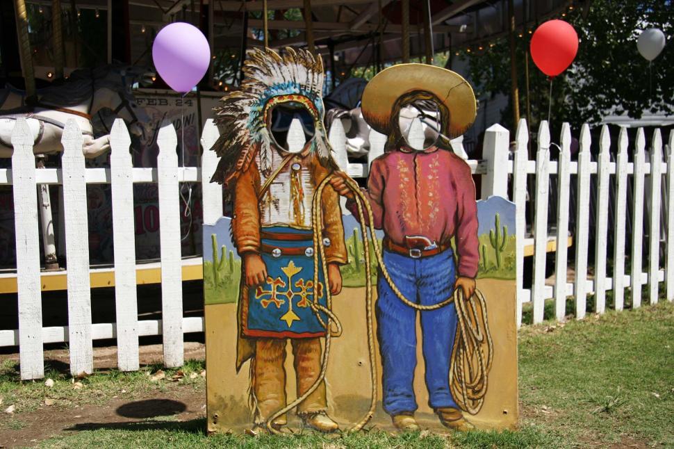 Free Image of Cowboy and indian photo stand in 