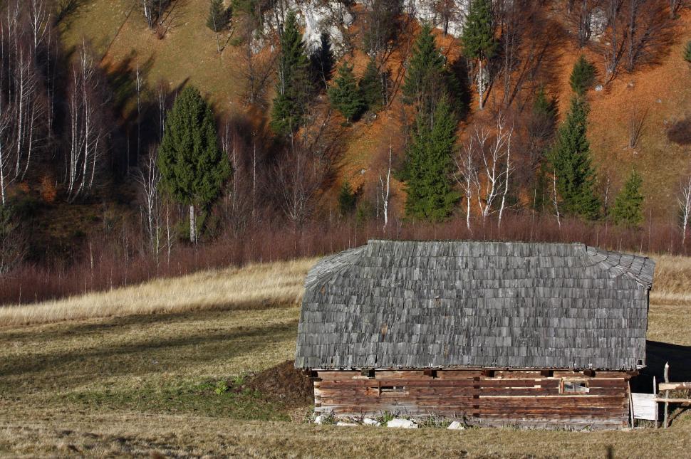 Free Image of Barn in Field With Mountain Background 