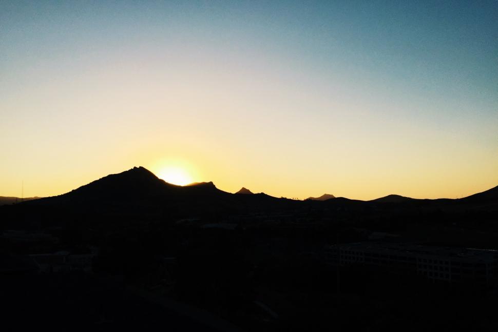 Free Image of Sun Setting Over Mountain Range 