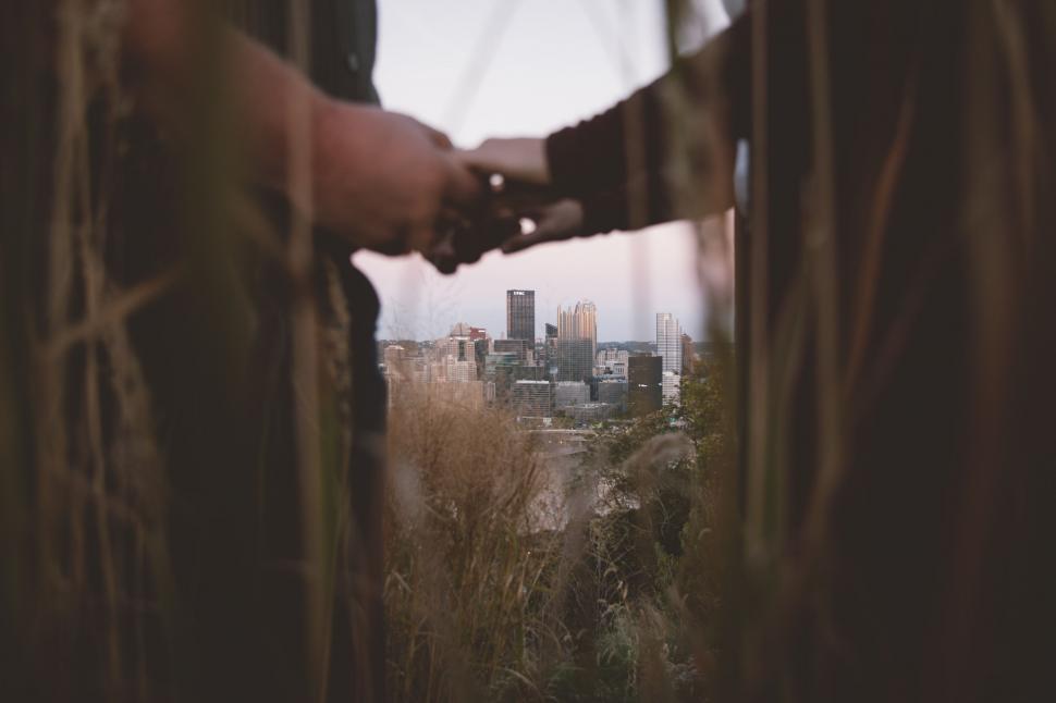 Free Image of Business Partners Shaking Hands in Front of Cityscape 