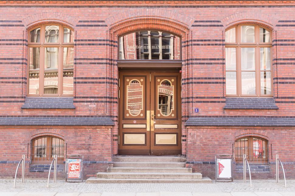 Free Image of Large Brick Building With Brown Door 