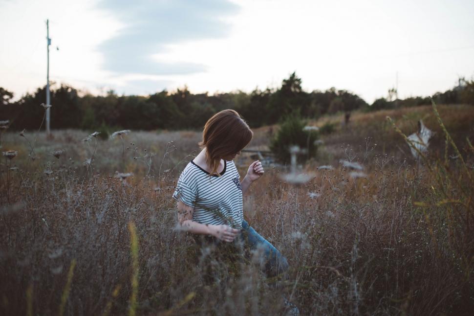 Free Image of Woman Standing in Field of Tall Grass 