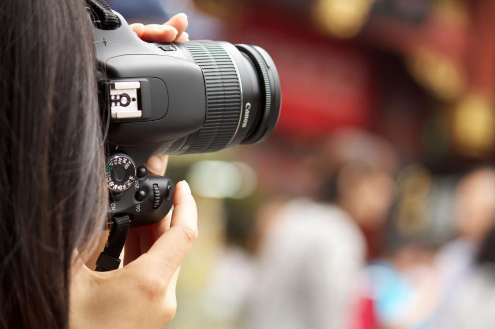 Free Image of Woman Taking a Picture With a Camera 