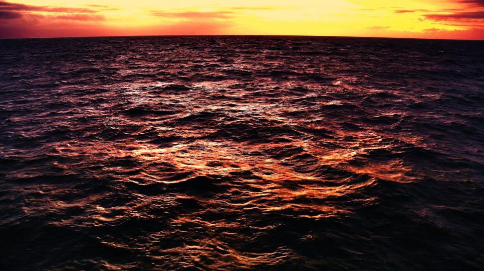 Free Image of Large Body of Water Under a Cloudy Sky 