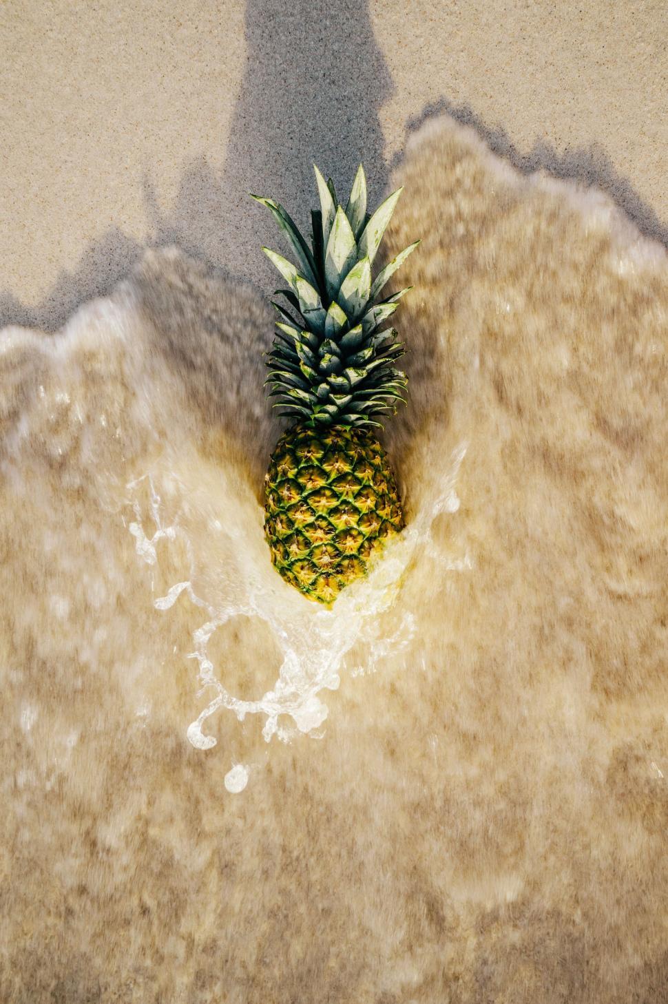 Free Image of Pineapple on Sandy Beach 