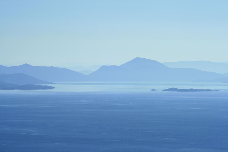 Free Image of Majestic Mountain Range Overlooking Large Body of Water 