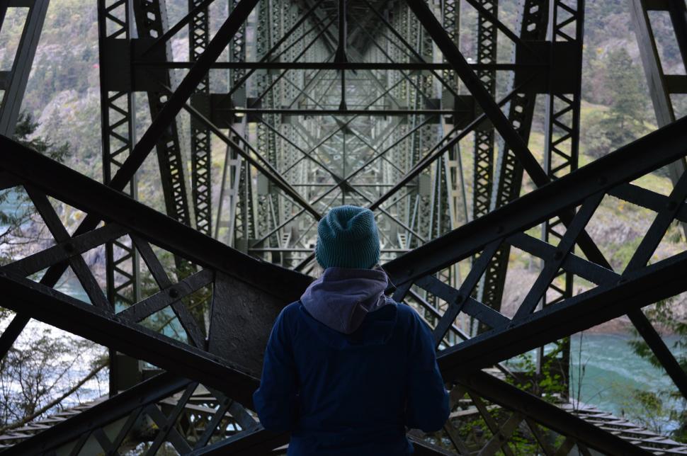 Free Image of Person Standing on Bridge Looking Down 