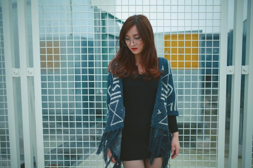 Free Image of Woman Standing in Front of Fence 