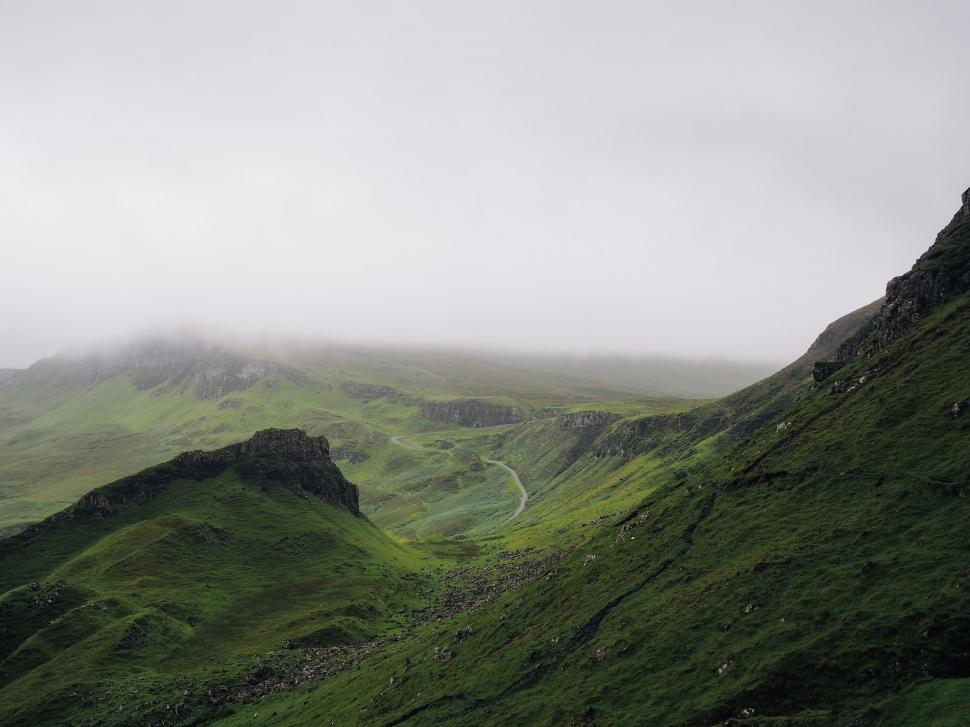 Free Image of Road Cutting Through Hill on Cloudy Day 