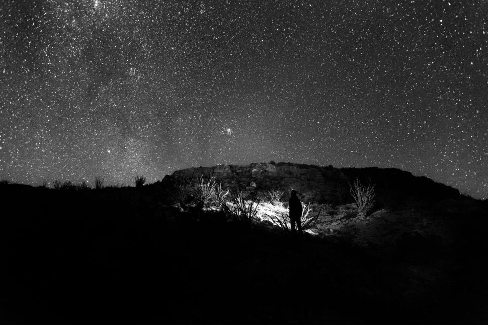 Free Image of Man Standing on Hill Under Starry Night Sky 