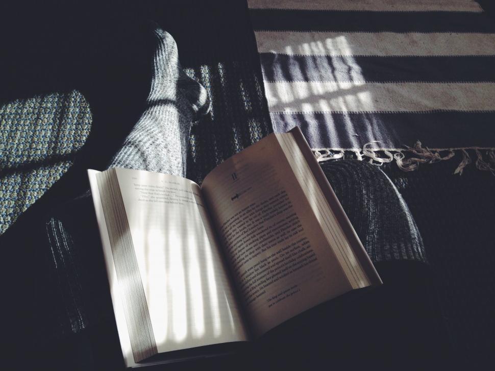Free Image of Open Book on Bed 