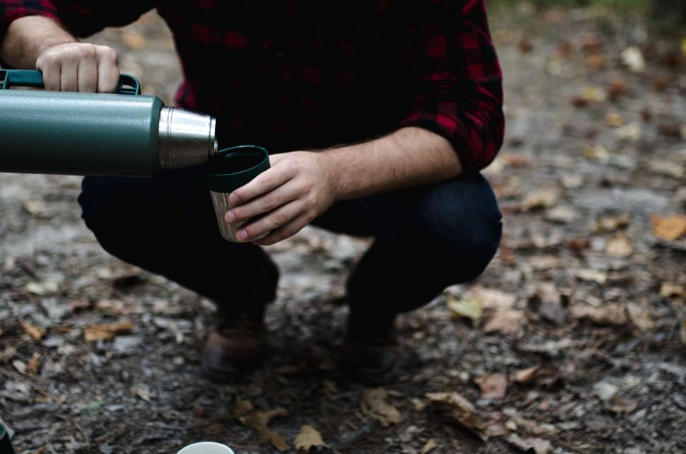 Free Image of Man Kneeling With Water Bottle 