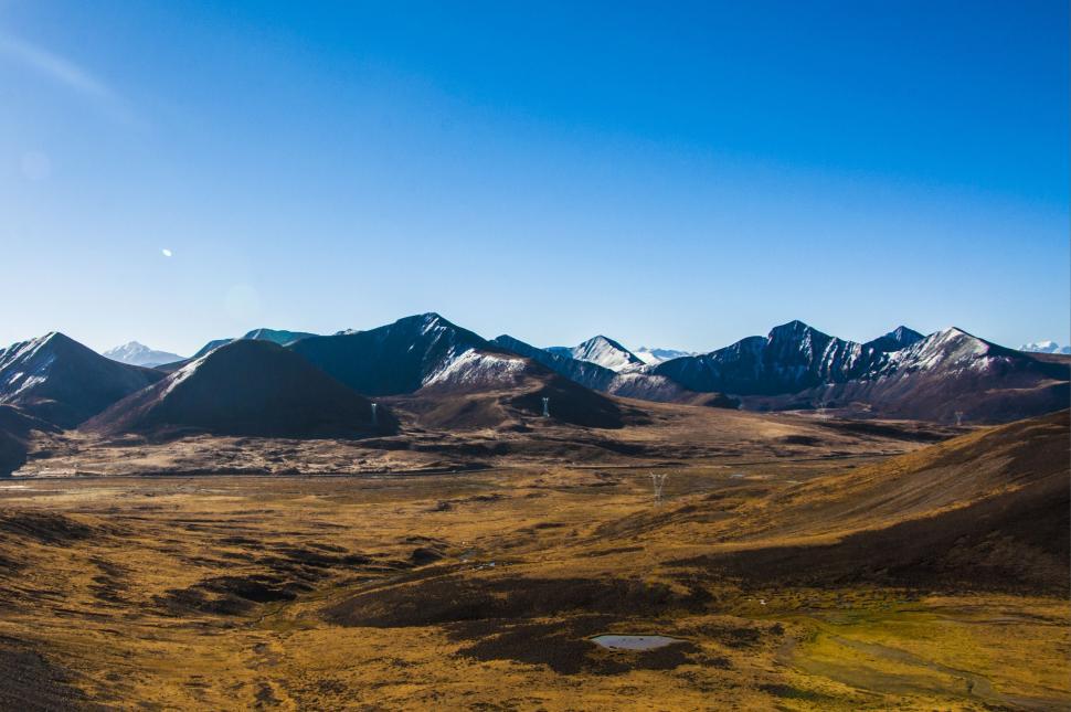 Free Image of Wide Open Field With Mountains in Background 