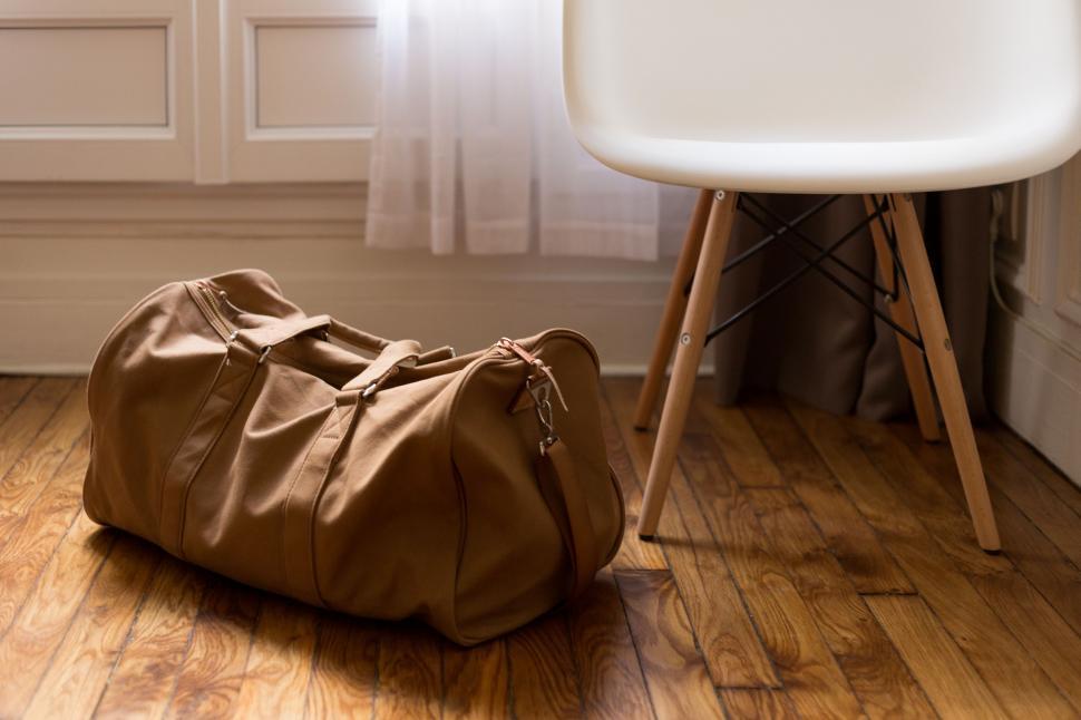 Free Image of Brown Bag Next to Chair 
