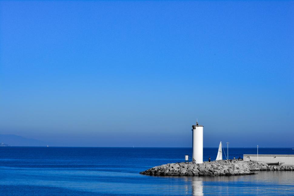 Free Image of Lighthouse on Rock Outcropping in Ocean 