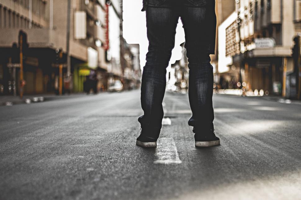 Free Image of Man Walking Down Street Holding Umbrella 