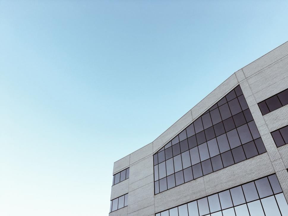 Free Image of Man Flying Kite in Front of Building 