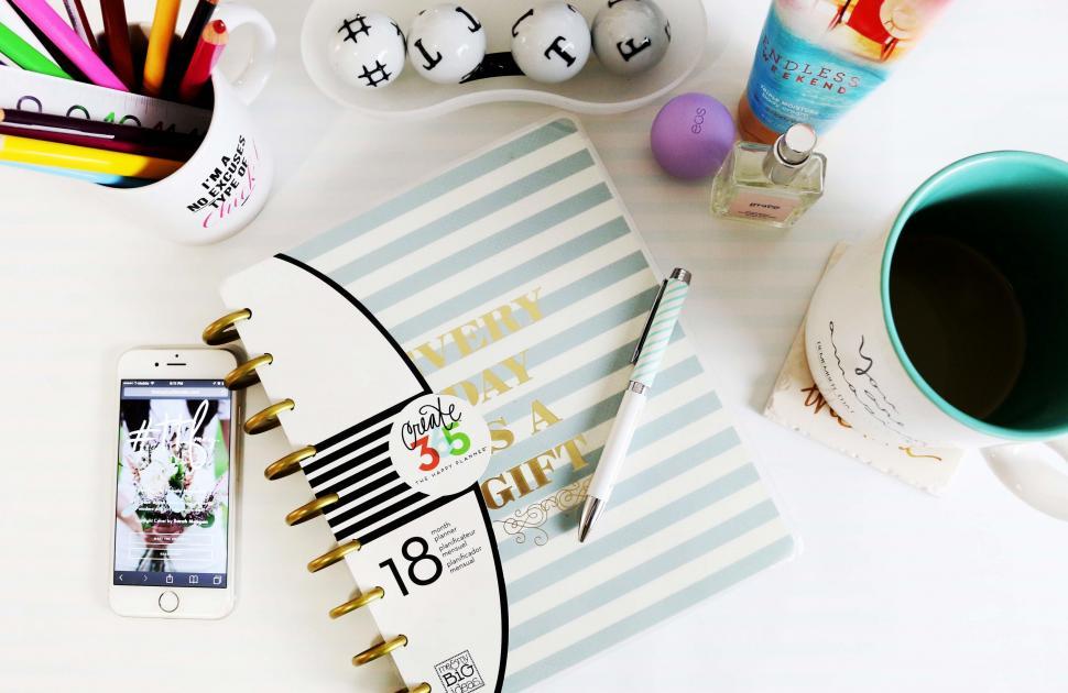 Free Image of White Table With Notebook and Coffee Cup 
