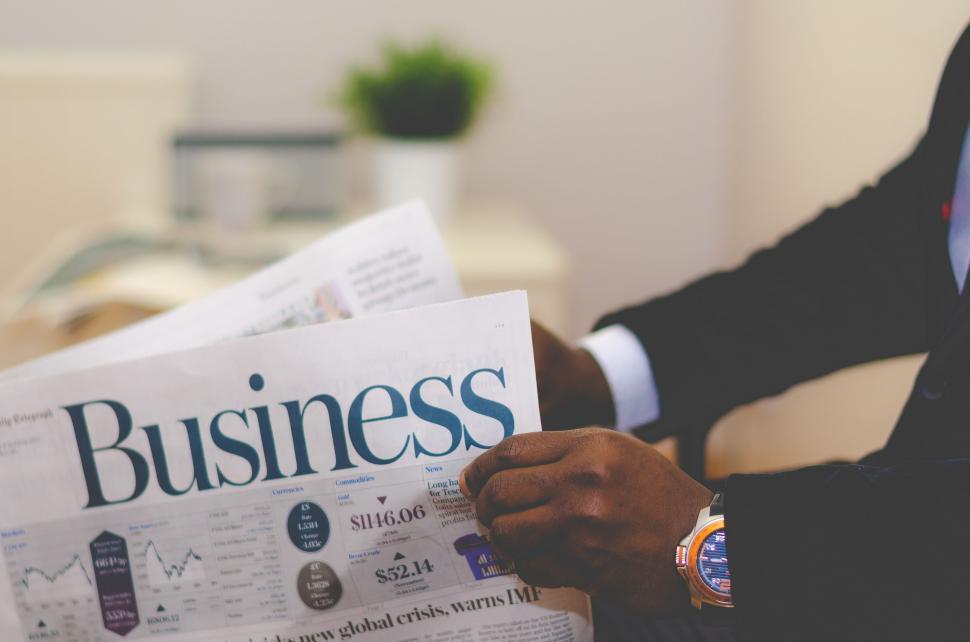 Free Image of Man in Suit Reading Newspaper 