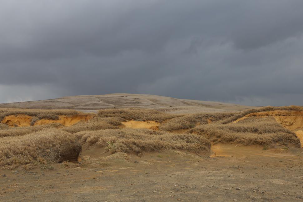 Free Image of Man Riding Horse Through Sandy Field 