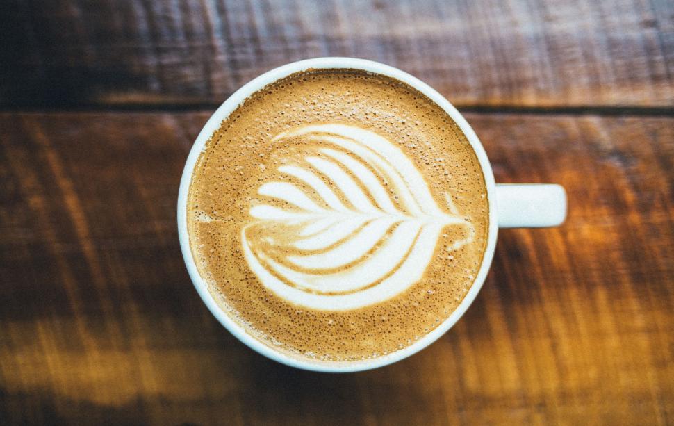 Free Image of Coffee Cup With Leaf Drawing 