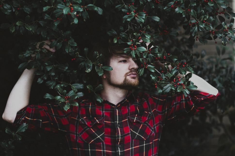 Free Image of Man Standing Under Tree With Hands On Head 