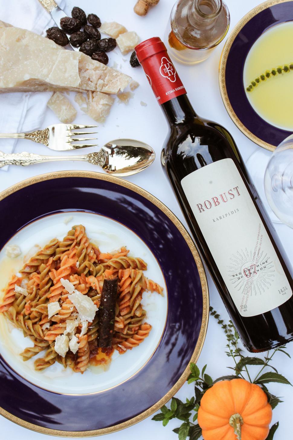 Free Image of Table Set With Plates of Food and Wine Bottle 