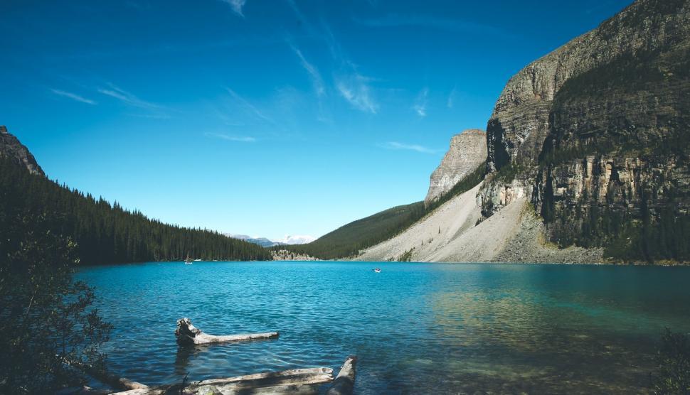 Free Image of Person Standing in Lake Surrounded by Mountains 