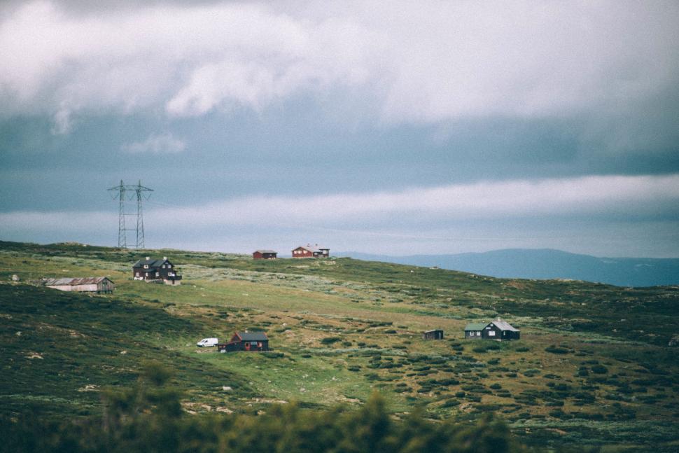 Free Image of Grassy Hill With Telephone Pole in the Distance 
