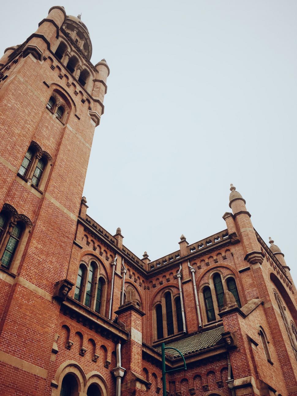 Free Image of Tall Brick Building With Clock 