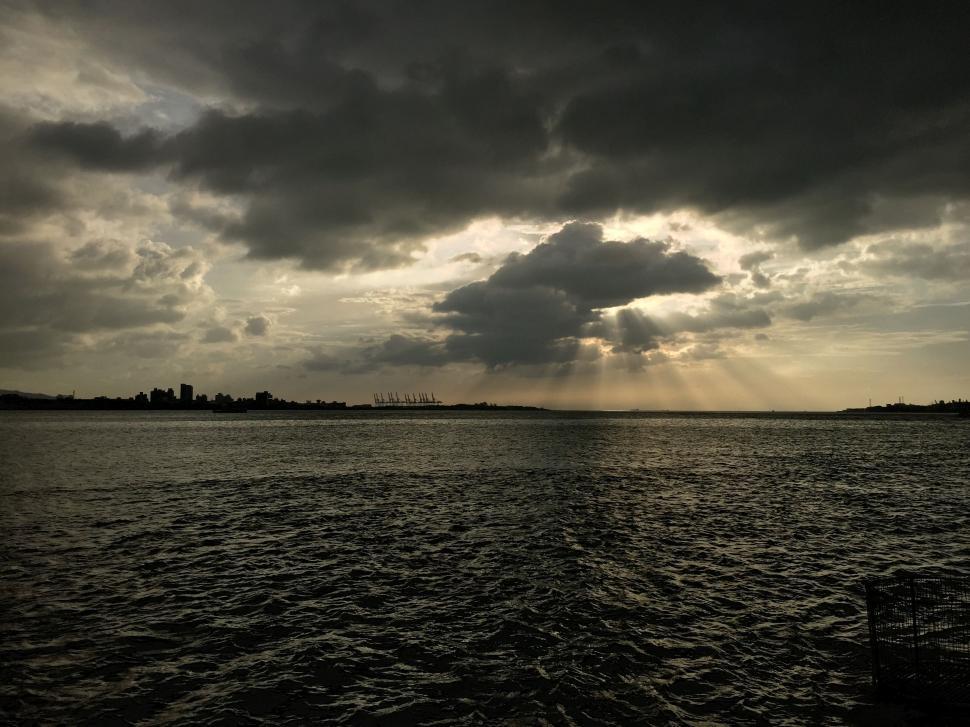 Free Image of Large Body of Water Under Cloudy Sky 