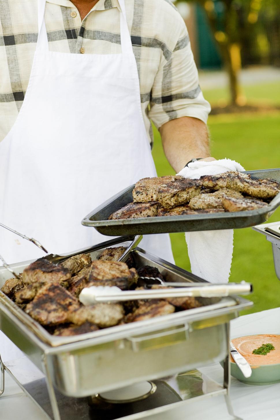 Free Image of Man Cooking on Grill 
