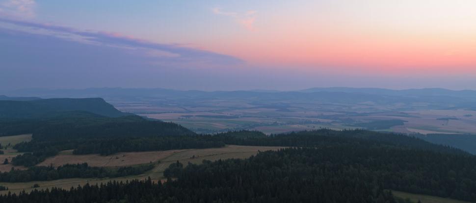 Free Image of Majestic Valley and Mountains Silhouetted at Sunset 