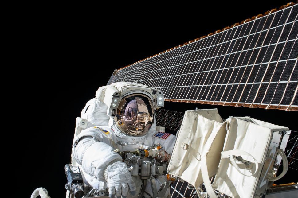 Free Image of Astronaut Sitting in Front of Satellite 