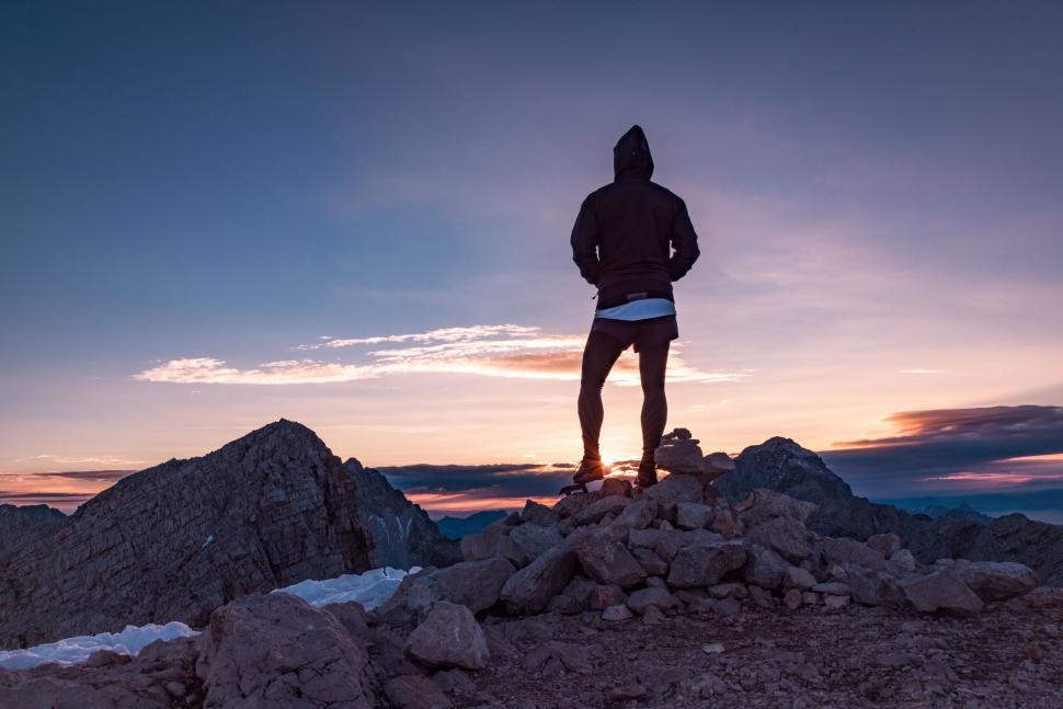 Free Image of Man Standing on Top of Rocky Mountain 